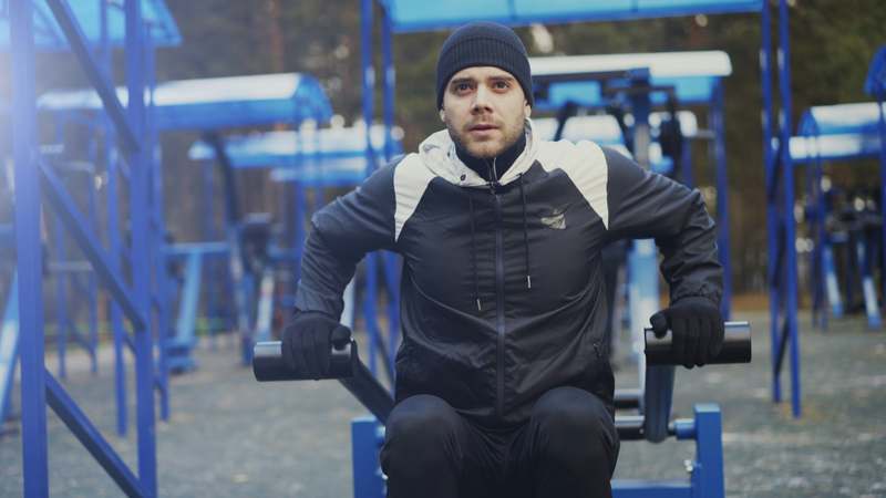 Person doing a bodyweight workout on a forest trail at sunrise